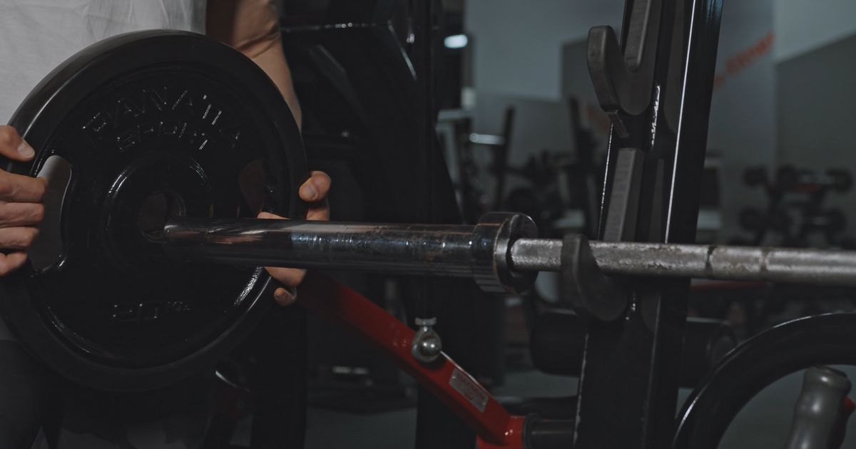 A weight plate sliding onto a lifting bar